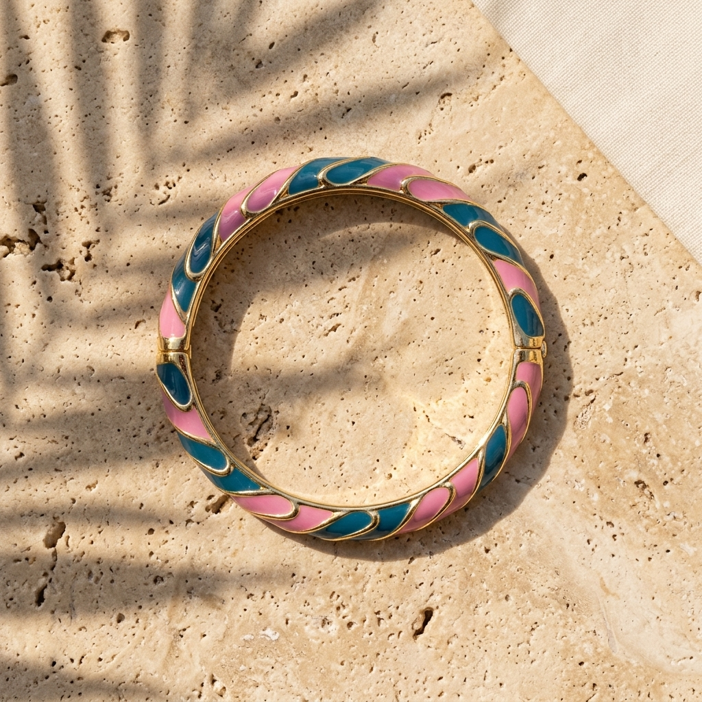 Waterproof enamel bangle on wet sand with water droplets