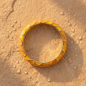Amber Wave Bangle — gold-tone enamel bangle on sand, waterproof 316L steel