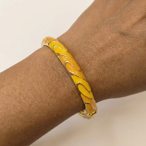 Amber Wave Bangle worn on wrist, waterproof nickel-free steel jewellery
