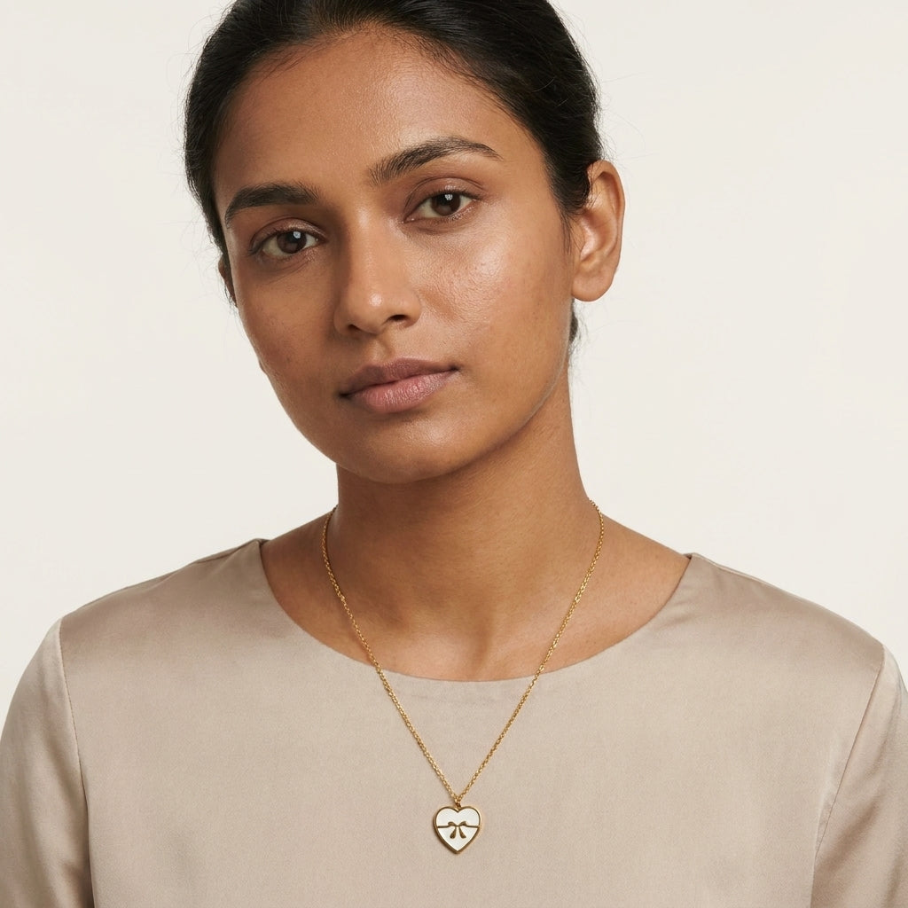 White Enamel Bow Heart Necklace worn on neck