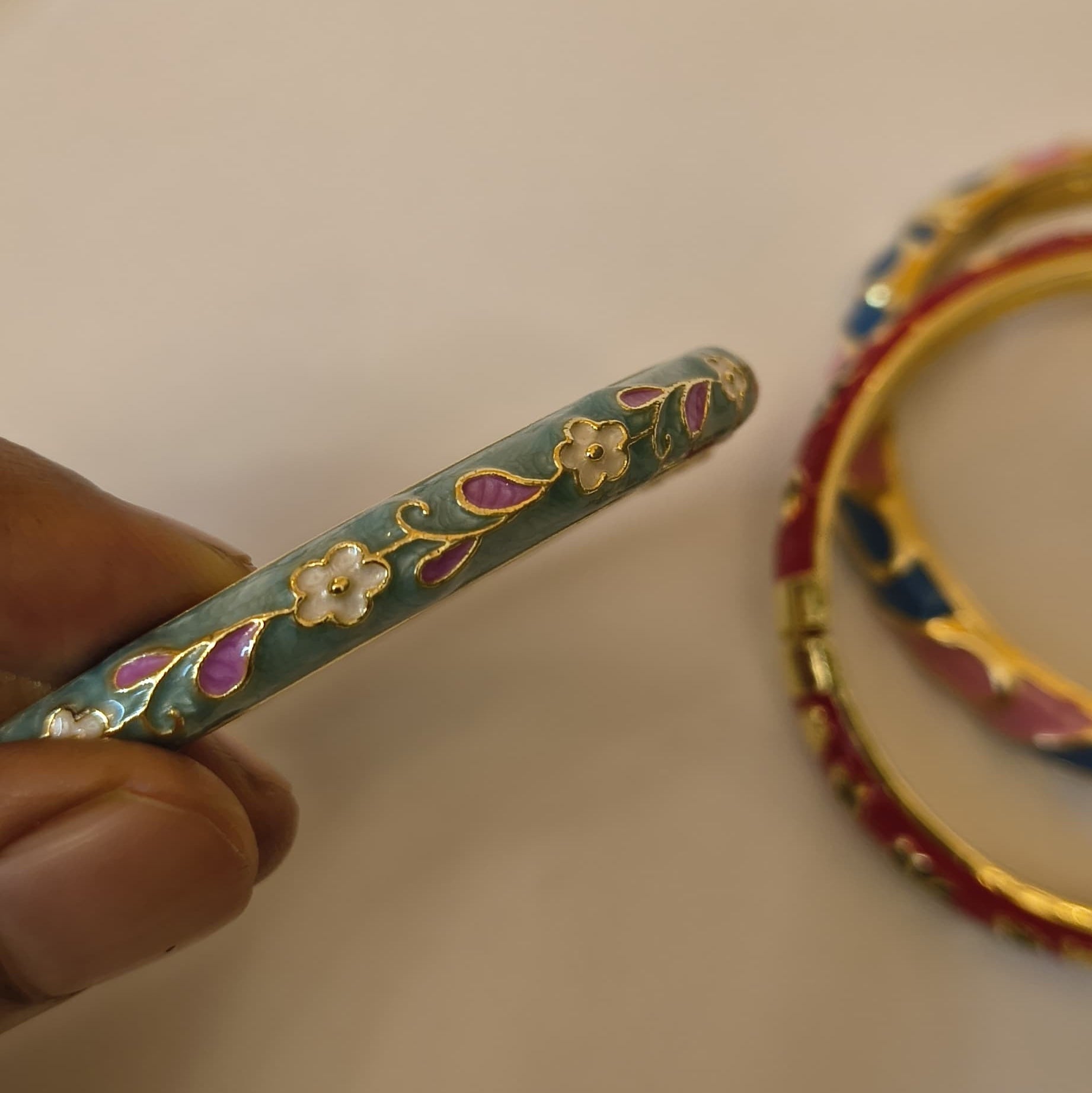 Sage green enamel bangle with pink and white floral vine pattern