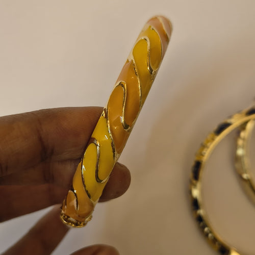 Amber and mustard enamel wave bangle with gold-tone trim